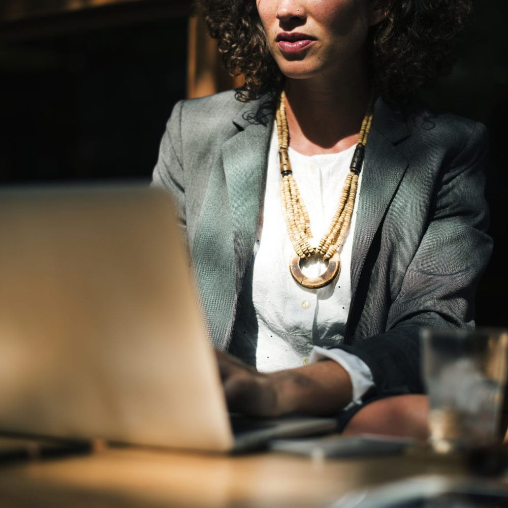 Woman working with laptop at coffee shop